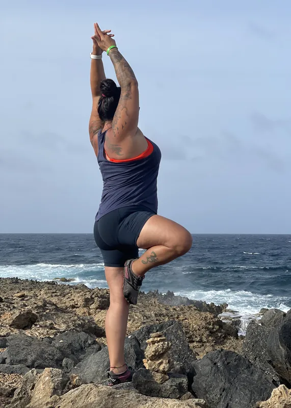 Angela in tree pose by the ocean